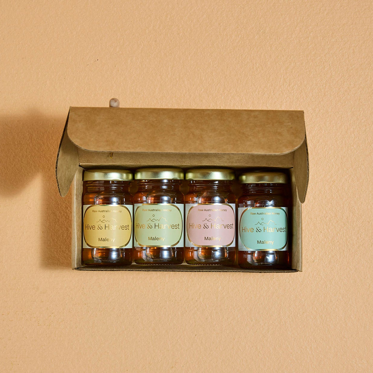 Maleny Golden Moments Honey Gift Set – Wildflower Honey Petite Jars with Heartfelt Messages
4 jars with messages: "Buzzing with Thanks", "You're the Bee's Knees", "Don't Worry, Bee Happy", & "Spread the Love"
Yellow Jar, Eucalyptus Green Jar, Pink Jar, Teal Green Jar, Mini Honey Dipper & Gift Box